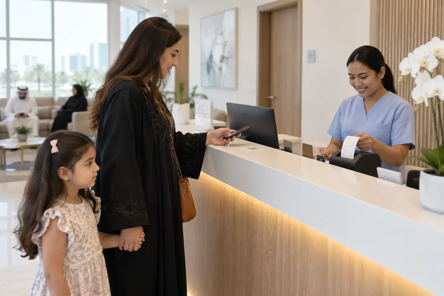 A mother holding her daughter’s hand scans a code card on the reception counter of a clinic in Al Barsha while the receptionist prints her receipt.